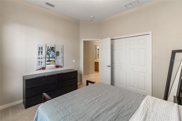bedroom featuring baseboards, a closet, and light carpet
