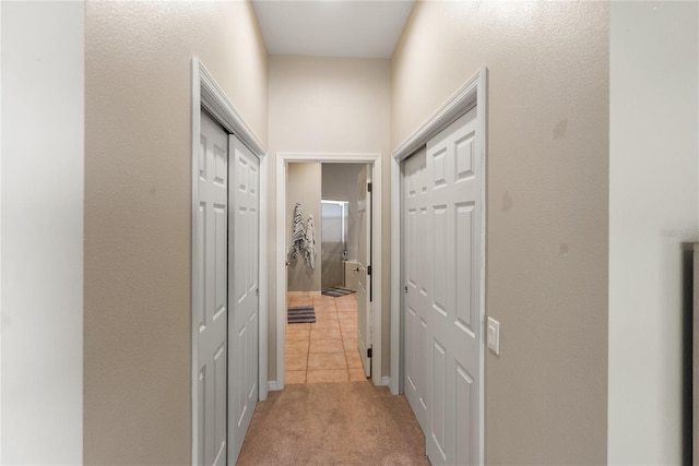 hall featuring light colored carpet