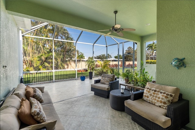 view of patio / terrace featuring outdoor lounge area, ceiling fan, glass enclosure, and fence