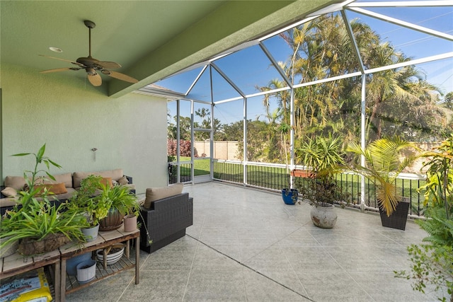 view of patio with glass enclosure, a ceiling fan, and an outdoor hangout area