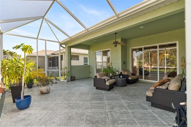 view of patio featuring outdoor lounge area, ceiling fan, and a lanai