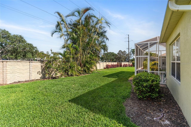view of yard featuring glass enclosure