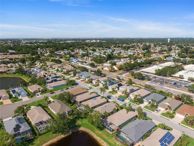 aerial overview of property's location with a large body of water and nearby suburban area