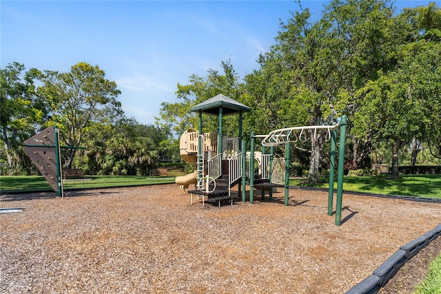 community jungle gym with view of wooded area