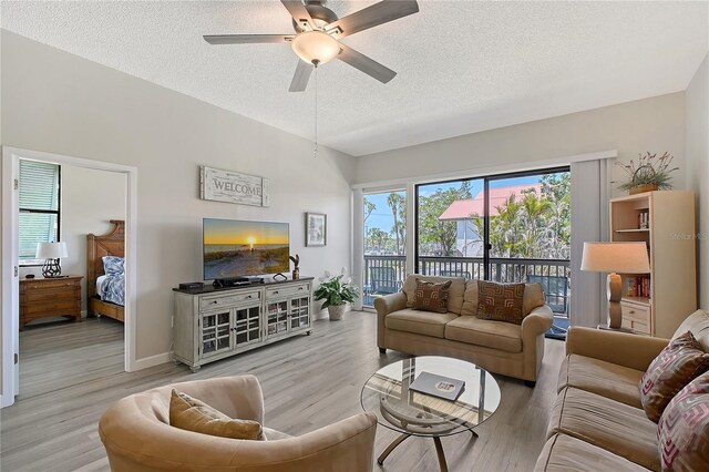 1159 Lake House Cir Unit C120, Sarasota, FL 34242 - living area featuring a textured ceiling, ceiling fan, and wood finished floors