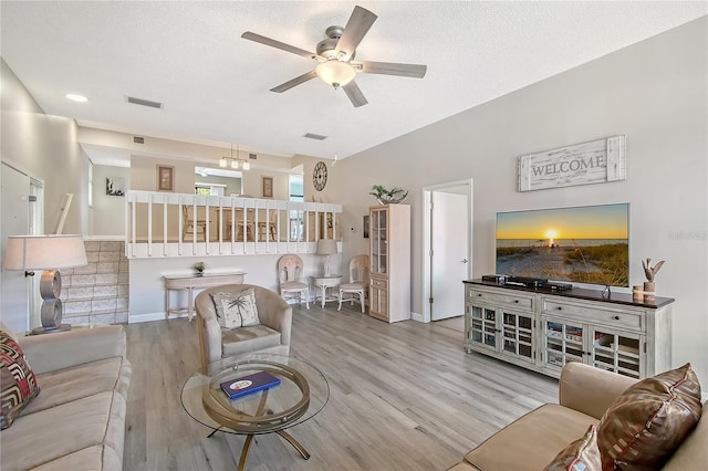 1159 Lake House Cir Unit C120, Sarasota, FL 34242 - living area featuring ceiling fan, wood finished floors, a textured ceiling, and baseboards