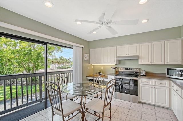 1159 Lake House Cir Unit C120, Sarasota, FL 34242 - kitchen featuring stainless steel appliances, white cabinets, under cabinet range hood, recessed lighting, and ceiling fan