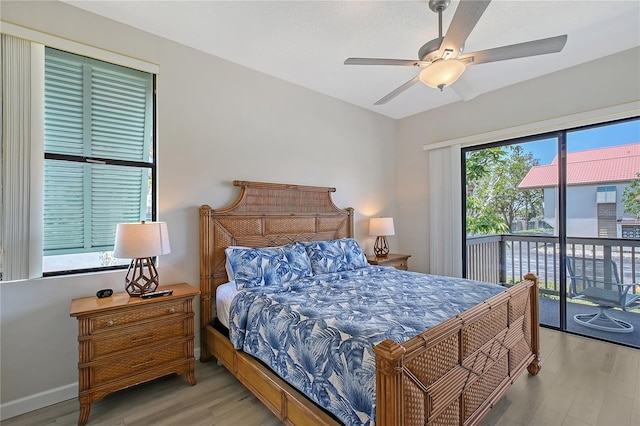 1159 Lake House Cir Unit C120, Sarasota, FL 34242 - bedroom featuring access to exterior, wood finished floors, and ceiling fan