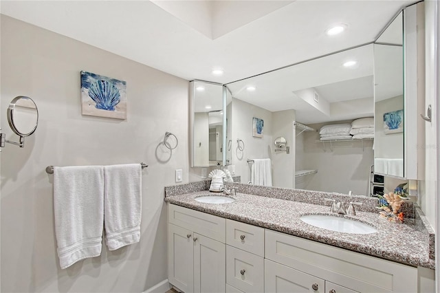1159 Lake House Cir Unit C120, Sarasota, FL 34242 - bathroom featuring a walk in closet, recessed lighting, and double vanity