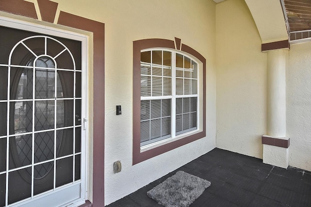 view of exterior entry featuring stucco siding