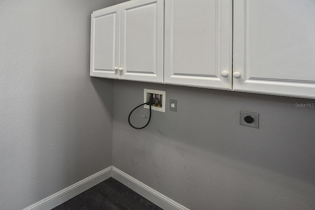 washroom featuring baseboards, washer hookup, cabinet space, dark wood-style floors, and electric dryer hookup
