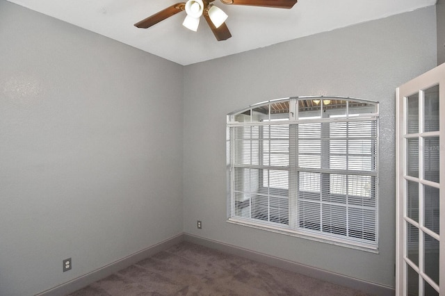 empty room with ceiling fan, carpet flooring, and baseboards