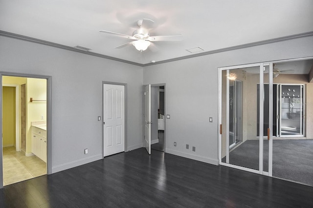 unfurnished bedroom featuring crown molding, visible vents, wood finished floors, and baseboards