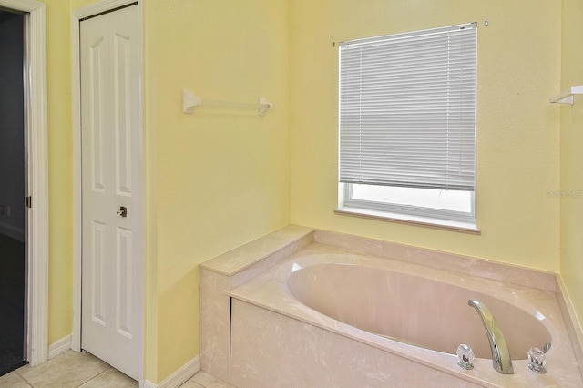bathroom featuring tile patterned floors, a closet, and a bath