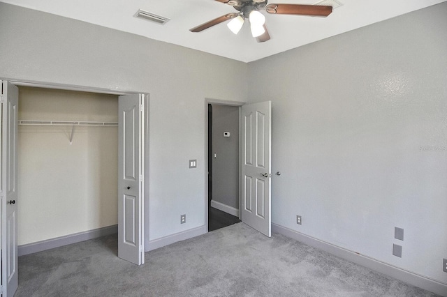 unfurnished bedroom featuring carpet flooring, a ceiling fan, a closet, visible vents, and baseboards