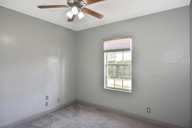 carpeted empty room with baseboards and ceiling fan
