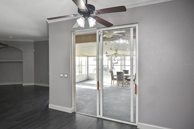unfurnished room with crown molding, baseboards, a ceiling fan, and dark wood finished floors