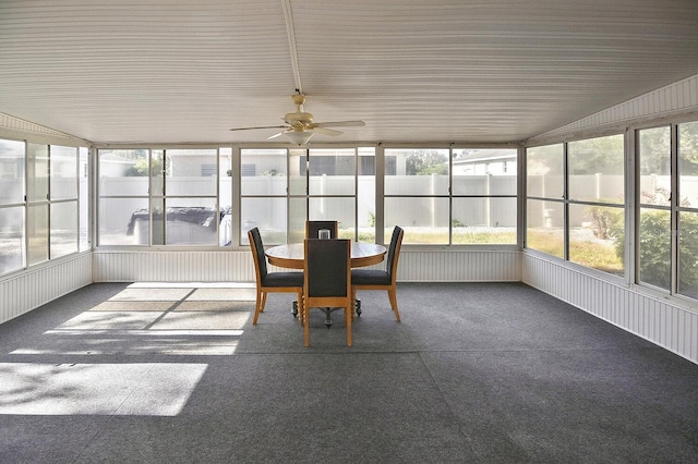 sunroom / solarium with outdoor dining area and a ceiling fan