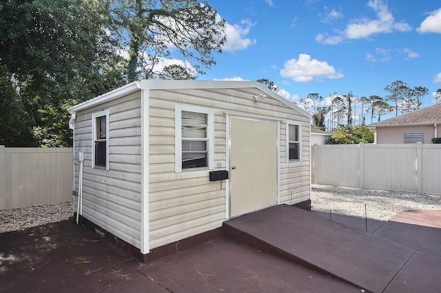 view of shed featuring fence