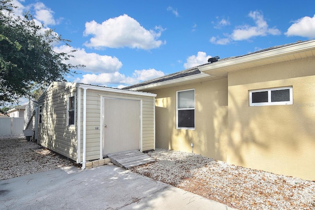 exterior space with stucco siding and a patio area