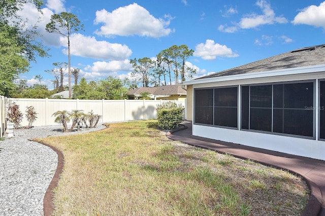 view of yard with a fenced backyard and a sunroom