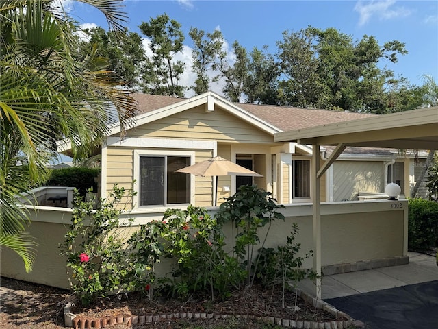 view of front of property featuring a shingled roof and fence