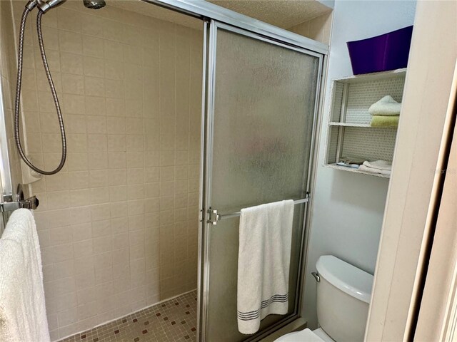 full bath with a shower stall and toilet