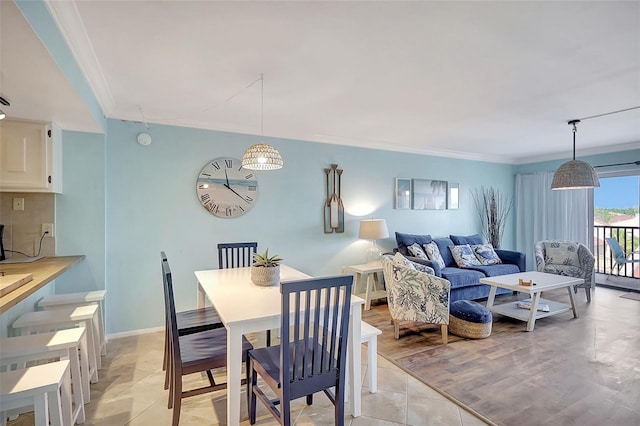 dining space featuring light tile patterned floors and ornamental molding