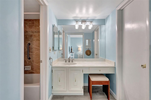 bathroom with baseboards, vanity, and shower / bath combination