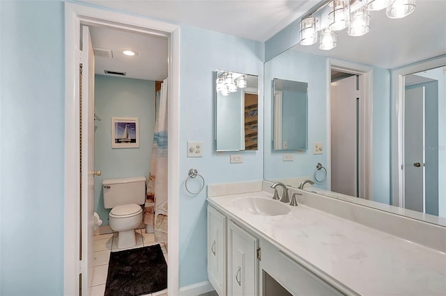 bathroom featuring toilet, vanity, visible vents, tile patterned flooring, and baseboards