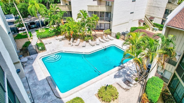 community pool featuring a patio and fence