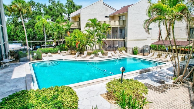 pool featuring a patio area and fence
