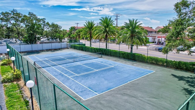 view of sport court featuring fence