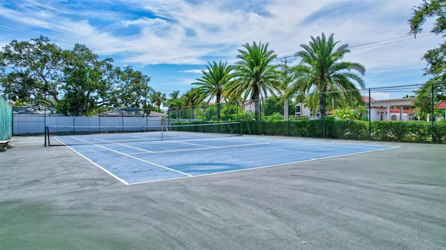 view of tennis court with fence and community basketball court