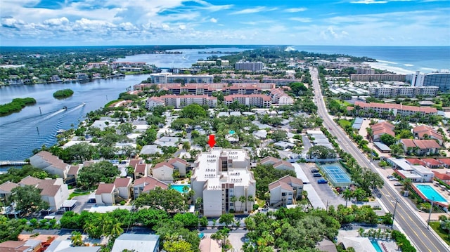 birds eye view of property featuring a city view and a water view