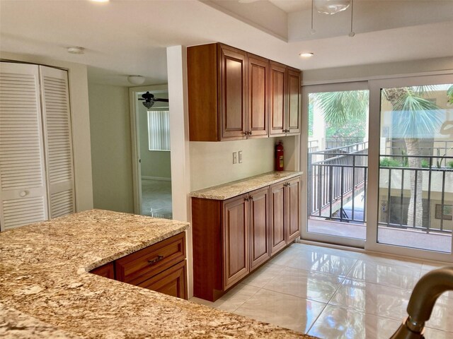 6430 Sun Eagle Ln Unit 203, Bradenton, FL 34210 - kitchen with light stone countertops, brown cabinets, and recessed lighting