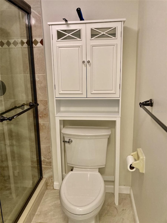 6430 Sun Eagle Ln Unit 203, Bradenton, FL 34210 - bathroom featuring a stall shower, toilet, and baseboards