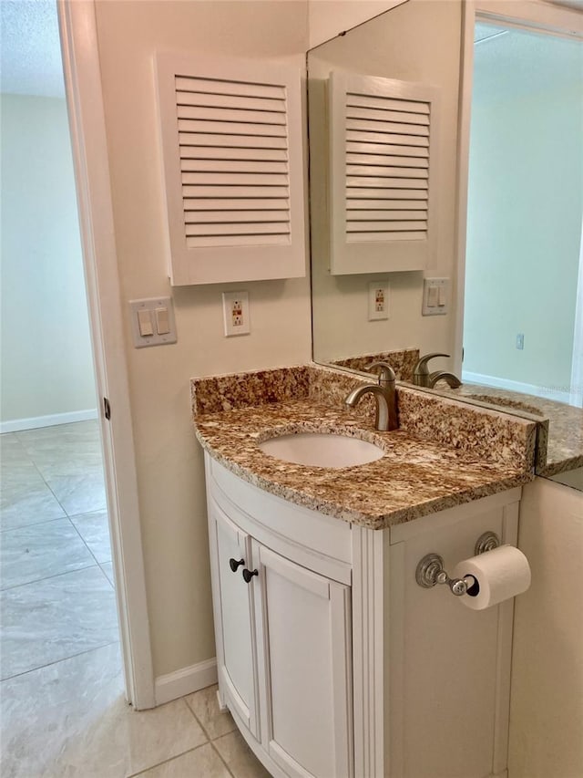 6430 Sun Eagle Ln Unit 203, Bradenton, FL 34210 - bathroom featuring vanity, baseboards, and tile patterned flooring