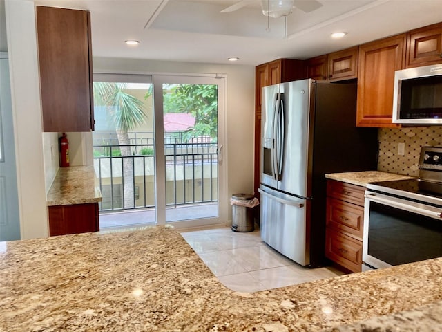 6430 Sun Eagle Ln Unit 203, Bradenton, FL 34210 - kitchen featuring appliances with stainless steel finishes, tasteful backsplash, recessed lighting, a ceiling fan, and brown cabinets