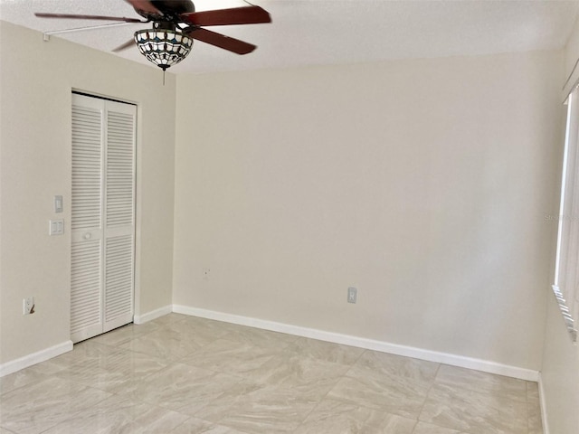 6430 Sun Eagle Ln Unit 203, Bradenton, FL 34210 - unfurnished bedroom with a closet, baseboards, and a ceiling fan