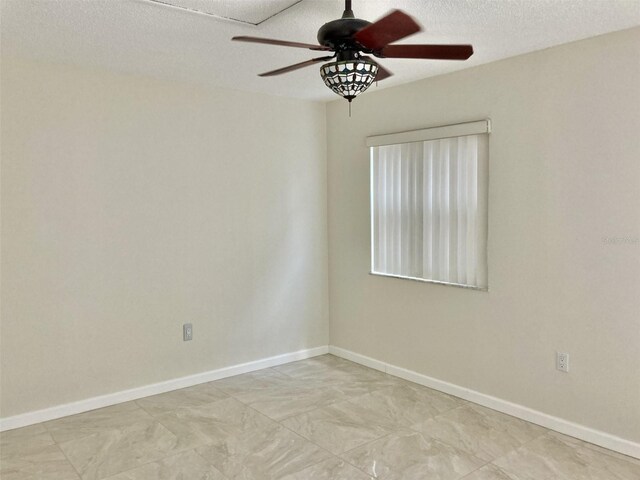 6430 Sun Eagle Ln Unit 203, Bradenton, FL 34210 - unfurnished room with ceiling fan, baseboards, and a textured ceiling