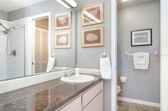 1424 Mediterranean Dr Unit 112, Punta Gorda, FL 33950 - bathroom with toilet, vanity, baseboards, and a shower