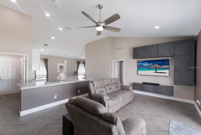 living area with a ceiling fan, baseboards, high vaulted ceiling, and recessed lighting