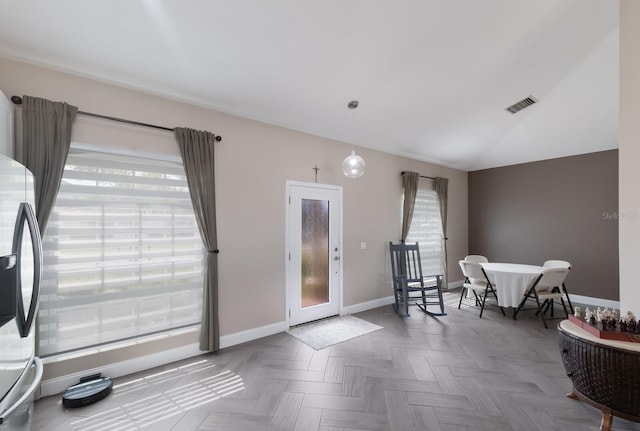 dining room featuring baseboards and vaulted ceiling