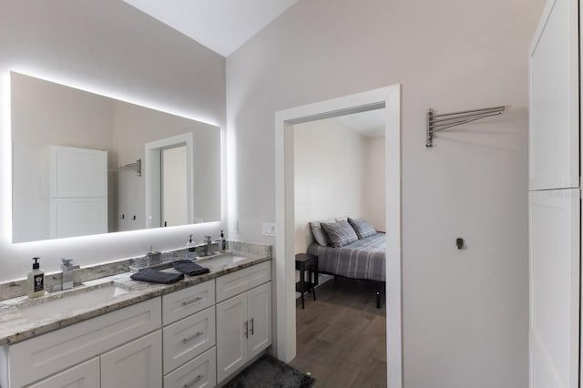full bath with wood finished floors and double vanity