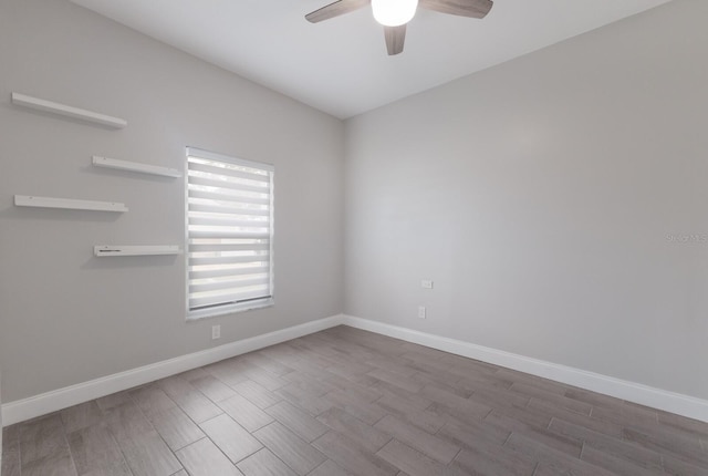 empty room featuring ceiling fan, wood finished floors, and baseboards