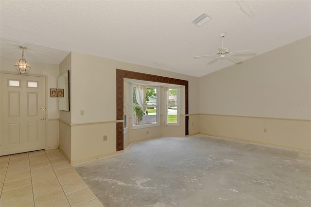 entryway featuring ceiling fan, a textured ceiling, and baseboards