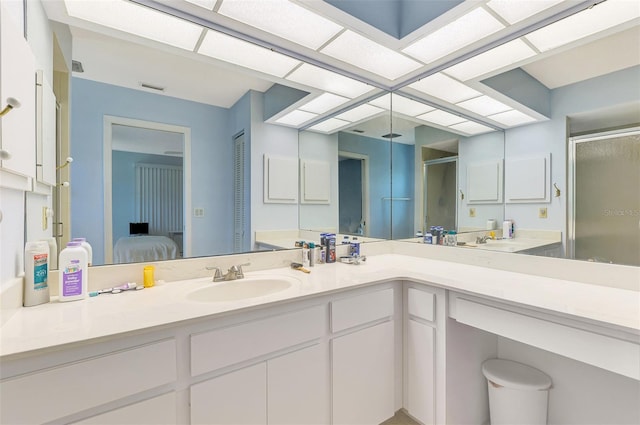 bathroom featuring a shower stall, vanity, and ensuite bathroom