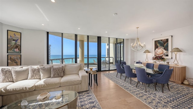 1241 Gulf Of Mexico Dr Unit 803, Longboat Key, FL 34228 - living room with a wall of windows, a chandelier, a water view, and recessed lighting