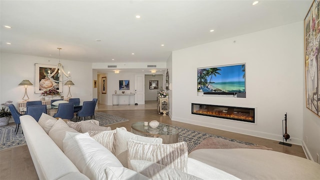 1241 Gulf Of Mexico Dr Unit 803, Longboat Key, FL 34228 - living area with recessed lighting, a glass covered fireplace, wood finished floors, baseboards, and a chandelier